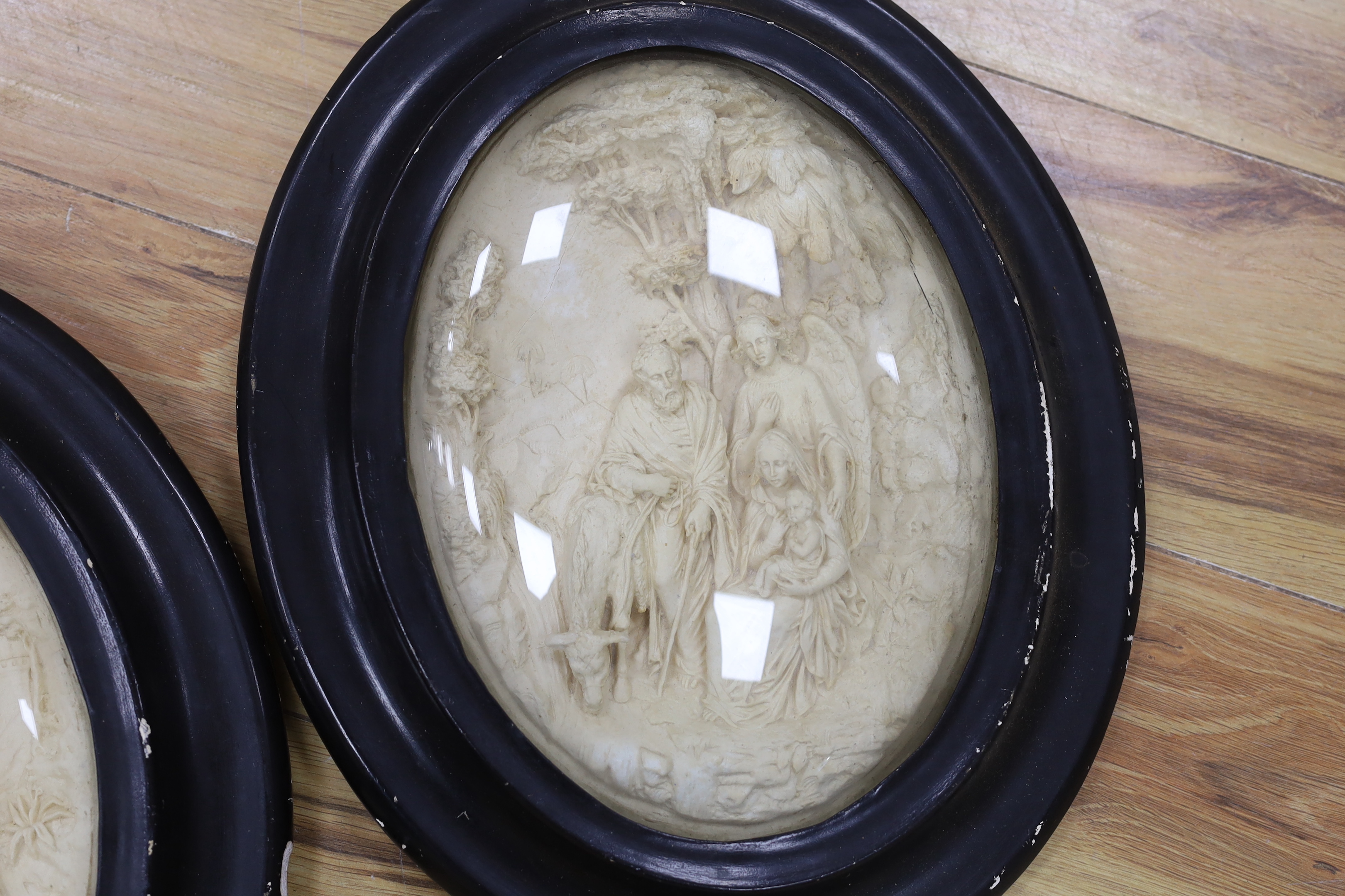 A pair of 19th century religious oval plaques, 29cm high not including frame